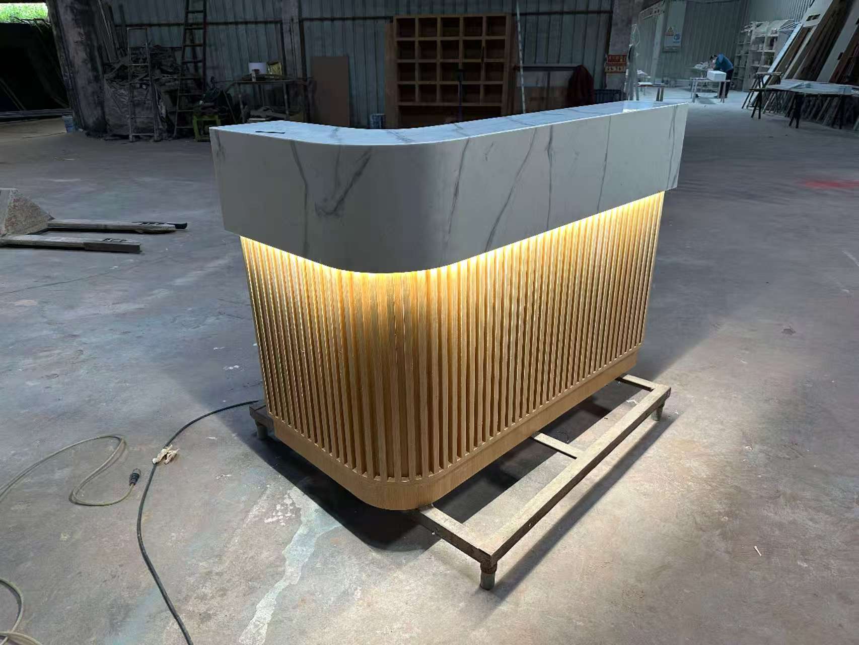 Corian marble reception countertop with wooden tube decoration