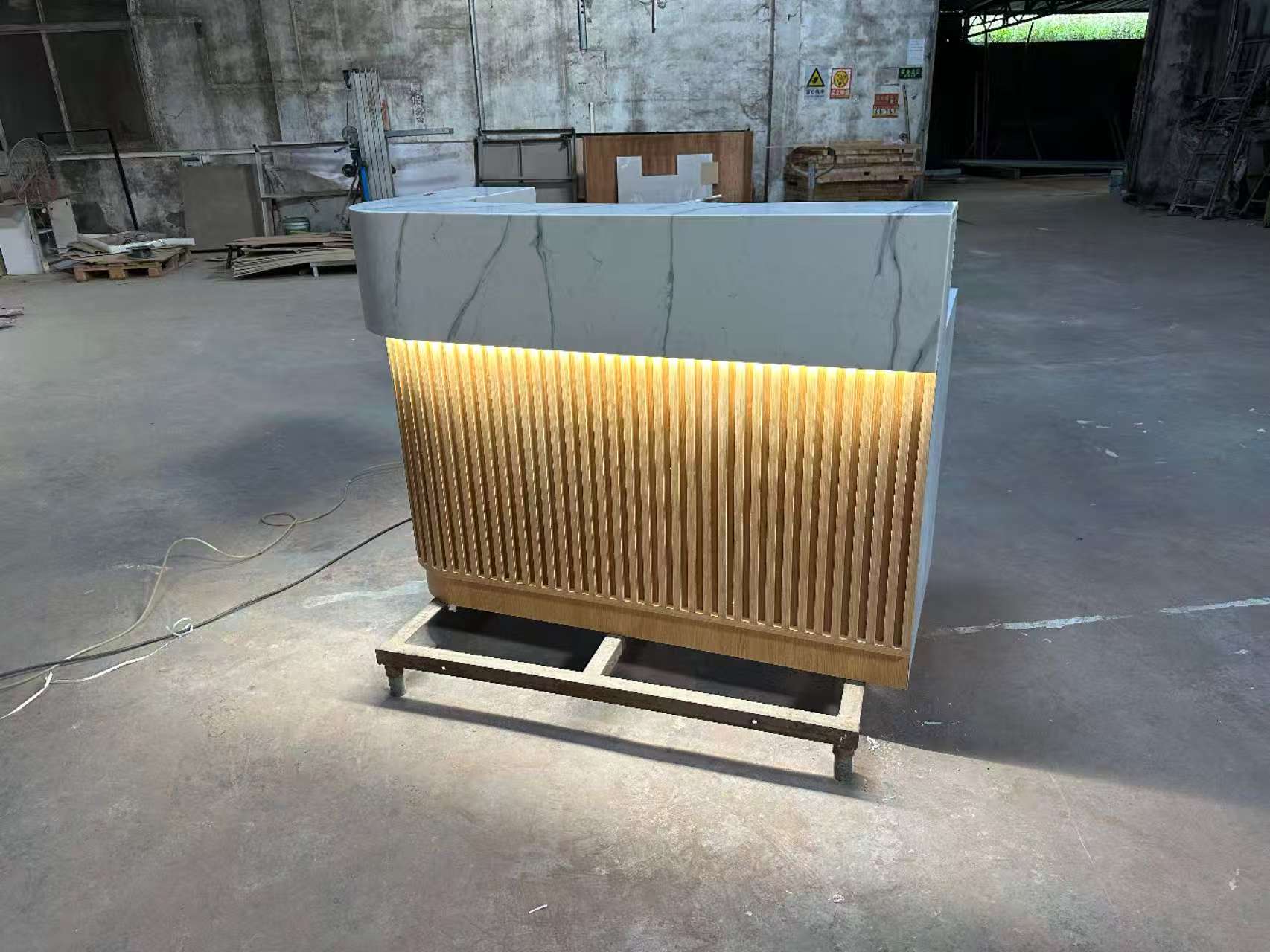 Corian marble reception countertop with wooden tube decoration