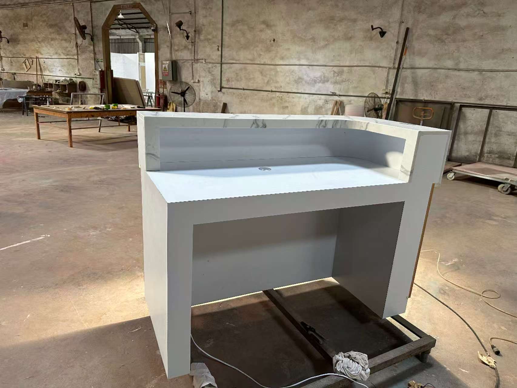 Corian marble reception countertop with wooden tube decoration